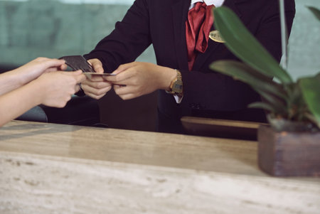 Two hands exchange a business card and transactions, highlighting networking, professional contact, and collaboration between individuals. People Exchange Business transactions, Networking And Professional Contactの写真素材