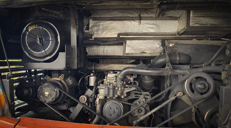 detailed view of a double decker bus engine bay showing belts, pulleys, radiator and hoses. Perfect...