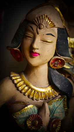 serene Bali dancer ceramic bust featuring closed eyes, bright lips, and gold embellishments. Ideal decorative sculpture for home, temple, or gallery displays, emphasizing art, culture, and craft.の写真素材
