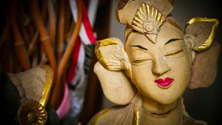 serene Bali dancer ceramic bust featuring closed eyes, bright lips, and gold embellishments. Ideal decorative sculpture for home, temple, or gallery displays, emphasizing art, culture, and craft.の写真素材