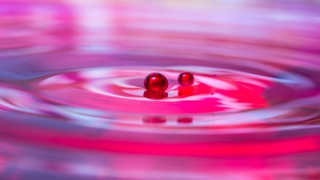 Blue water drop with red coloursの写真素材