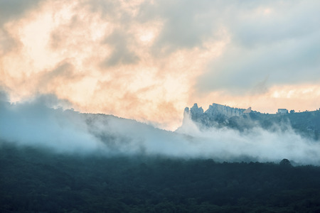 Mountains in clouds at sunset landscapeの写真素材