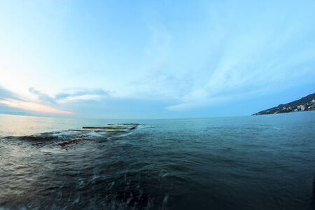 Sunrise on beach with rocks and sea landscapeの写真素材