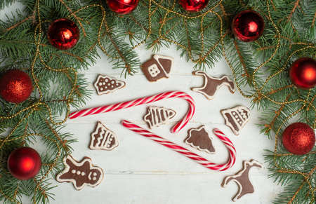 Christmas background on white wooden boards with biscuits and gifts,Christmas cookies