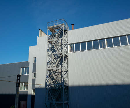 Part of an industrial building on a summer morning with shadows