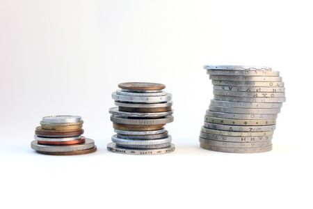 Stacks of coins from different countriesの写真素材