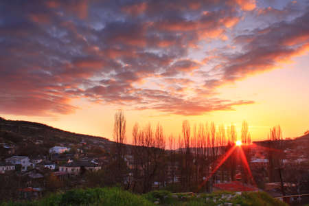 Sunsit over the spring townの写真素材