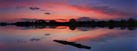 Panorama of the sunset on the lakeの写真素材