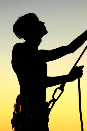 Silhouette insuring climber