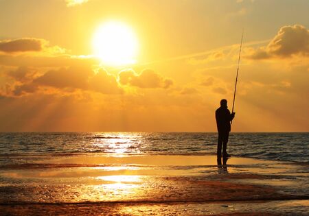 Reflection of a fisherman at dawn