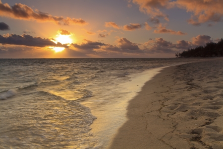Sunset on the sandy beach of a tropical islandの写真素材