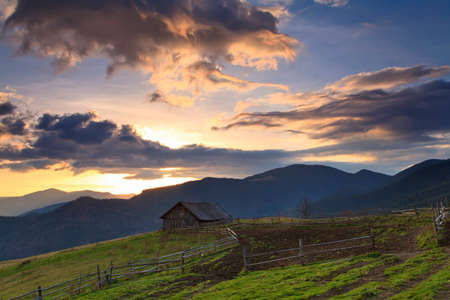Old house in the mountains at dawnの写真素材