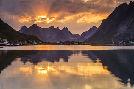 Cottage houses near the sea on the background of the amazing sunset. Norway.の写真素材