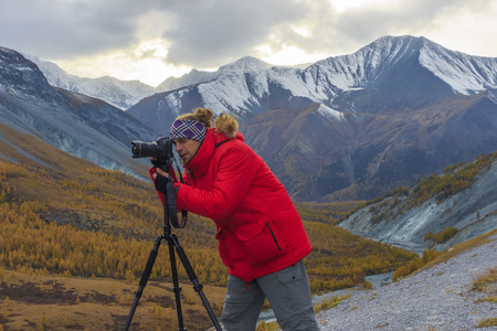 Photographer to shoot an amazing mountain landscape.の写真素材