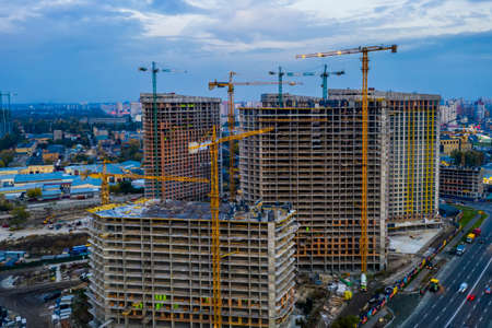 Construction site with cranes at sunset. Construction of an apartment buildingの写真素材