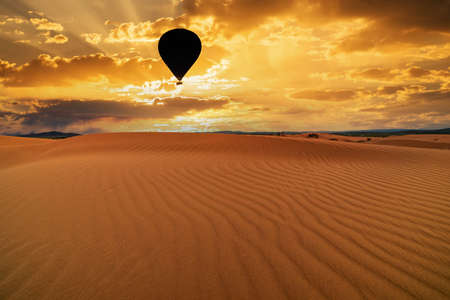 Sunset over the sand dunes in the desert. Arid landscape of the Sahara desertの写真素材