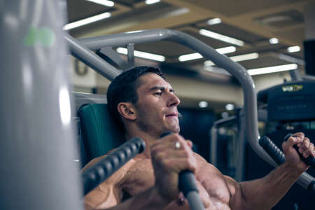 Bodybuilder doing hard exercise. The  work in the gym.の写真素材
