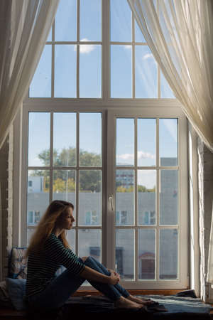 redhead girl and big window