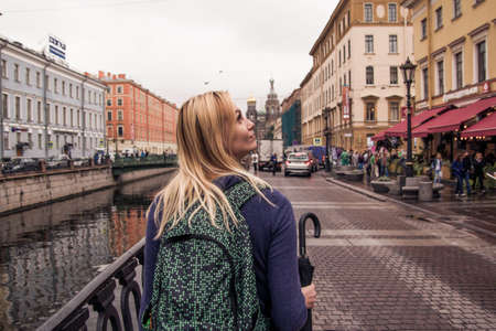 traveler walks in the old central part of autumn Saint-Petersburg.の写真素材