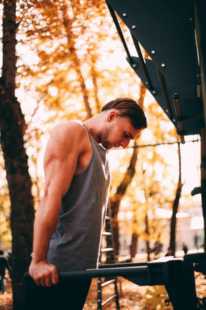 Young sexy athlete wrung out with parallel bars.
