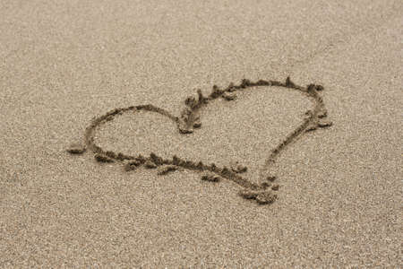 romantic heart drawn in the sand on the beach in Valentine's Dayの写真素材