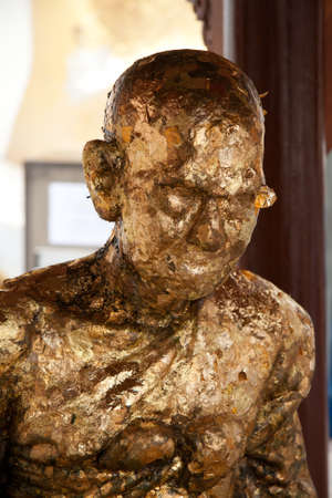 Buddhist altar and a golden statue in Thailandの写真素材