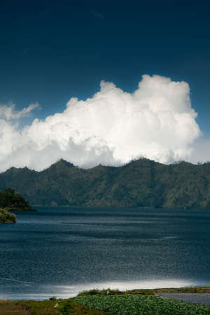 image of a beautiful landscape with mountains, lake, sky, cloudsの写真素材
