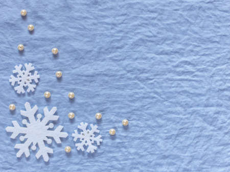 Christmas background. White snowflakes and pearls on a blue background