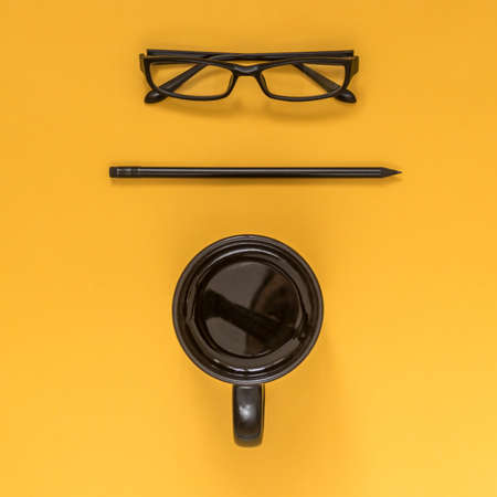 Flat lay black business accessories on yellow background with blank space for text. Top view. Copy space.の写真素材