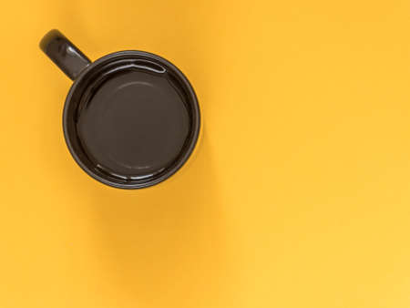 Flat lay black business accessories on yellow background with blank space for text. Top view. Copy space.の写真素材