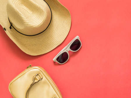 Flat lay traveler accessories on pink background with blank space for text. Top view travel or...