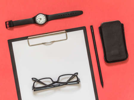 Flat lay black business accessories on pink background with blank space for text. Top view. Copy space.の写真素材