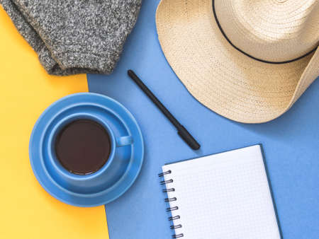 Top view goals list with notebook, cup of coffee on blue background. Flat lay, copy spaceの写真素材