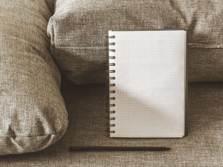 Top view goals list with notebook, pencil on grey fabric. Flat lay, copy spaceの写真素材