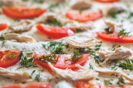 Pizza ingredients are closeup. Tomatoes, chicken, cheese, dill. Blurred backgroundの写真素材