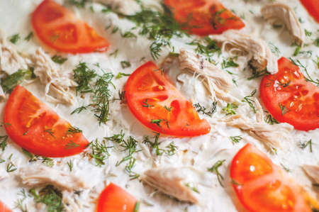 Pizza ingredients are closeup. Tomatoes, chicken, cheese, dill. Blurred backgroundの写真素材