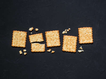 French cracker with sesame seeds on a black background. Flat lay, top view, copy spaceの写真素材