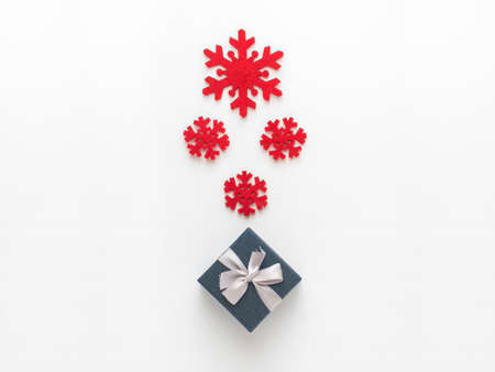 Christmas and New Year composition. Red snowflakes and gift box on white background, Flat lay, top...