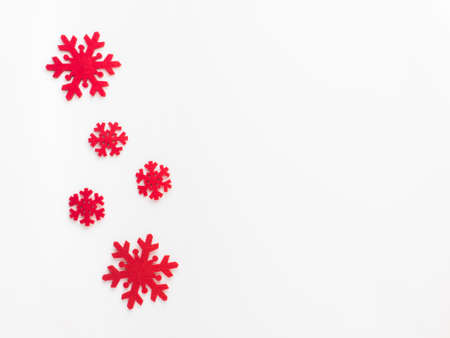Christmas and New Year composition. Red snowflakes on white background. Flat lay, top view, copy...