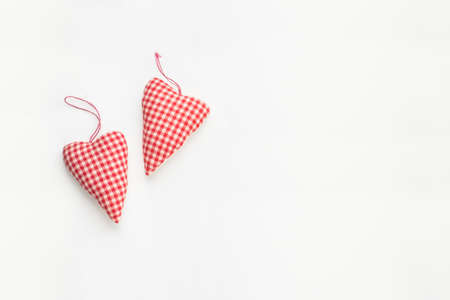 Love and Valentine day composition. Two red hearts on white background. Flat lay, top view, copy...