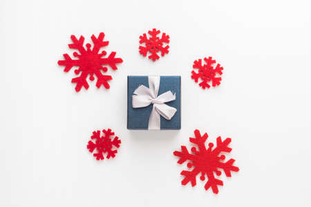 Christmas and New Year composition. Red snowflakes and gift box on white background, Flat lay, top...