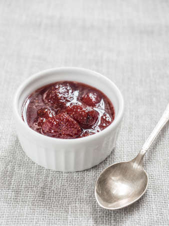 Homemade strawberry sweet delicious jam with whole berries on white background
