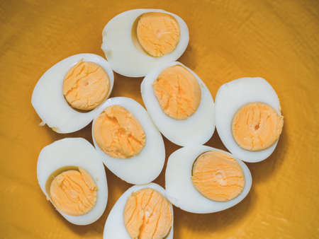 Boiled chicken eggs on a yellow plate.の写真素材