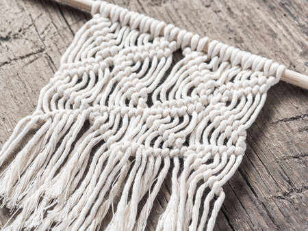 Macrame.  White thread, wooden background, closeupの写真素材