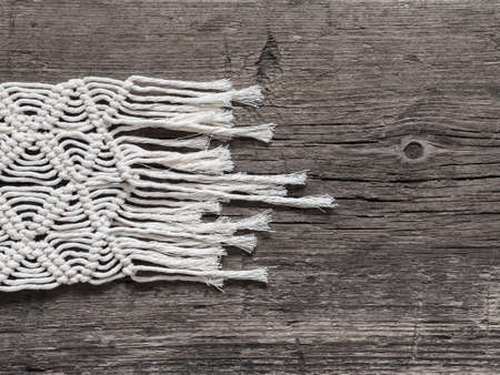 Macrame.  White thread, wooden background, closeupの写真素材