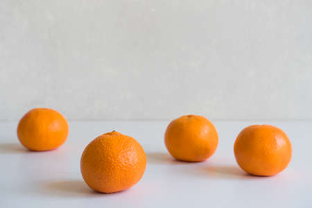 Fresh ripe mandarin oranges fruit or tangerines on a white table