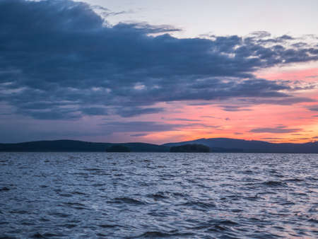 Calm, serenity, meditation concept. Sunset on the lake, quiet water, cloudless skyの写真素材