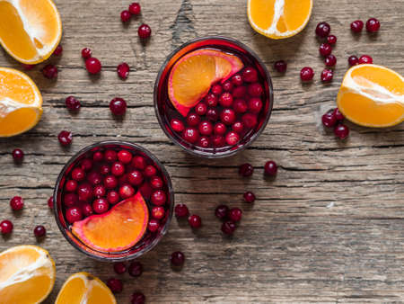 Traditional Christmas drink. Christmas hot mulled wine with oranges, cranberries and spices on a...