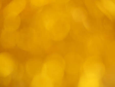 Gold bokeh. Yellow festive abstract background. Blurry lightの写真素材