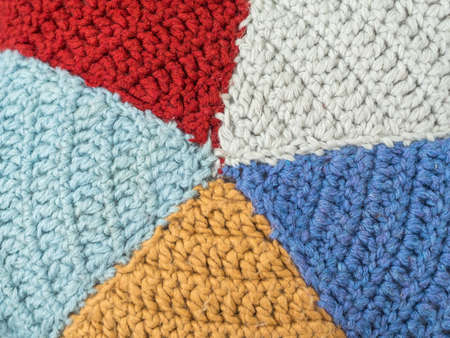 Slices knitted from colored yarn. Beautiful handmade background. Closeup pillowの写真素材